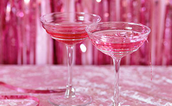 two cocktails with a pink background