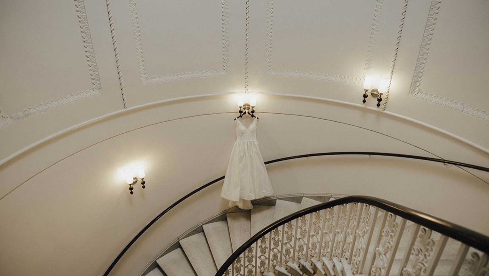 Wedding gown hangs in our marble staircase