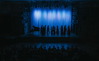 silhouette choir getting ready on stage