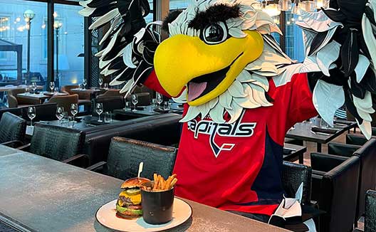Capitals Mascot with a Buger and French Fries